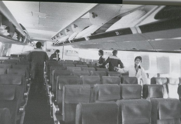 1991 Pan Am 'Fleet Service' staff in Frankfurt clean the economy cabin of a 747 prior to customer boarding.